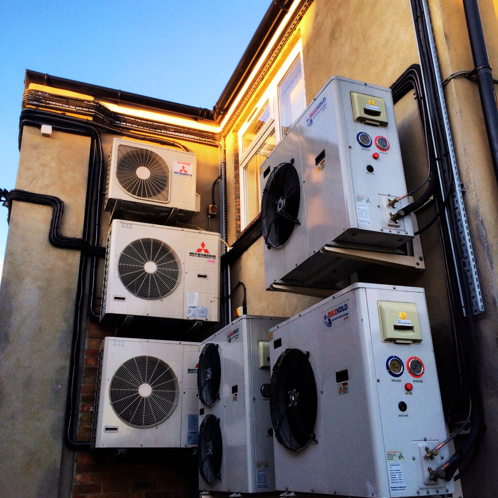 External Mitsubishi and Maxkold HVAC refrigeration units installed on a commercial building