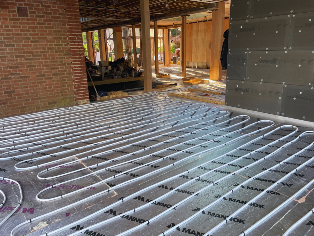 Underfloor heating pipework installed across a building floor during construction