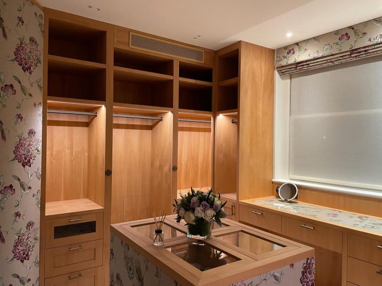 Discreet ducted air conditioning grille integrated above fitted bedroom cabinetry
